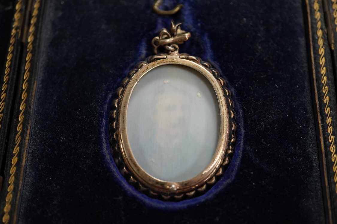 Early 20th century school, Portrait miniature of a gentleman, oval watercolour on ivory, housed in a silver and paste pendant frame, with gilt tooled leather case, 3.5 x 2.5cm CITES Submission reference 5A81E2GB